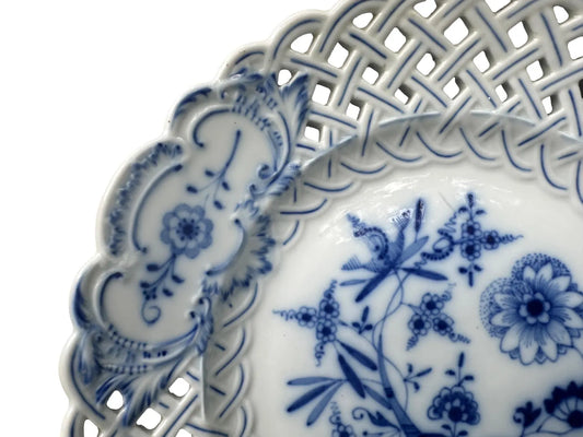 Close-up of an antique Meissen porcelain reticulated plate in the classic Blue Onion pattern. Beautifully detailed blue and white craftsmanship, perfect for collectors and decor