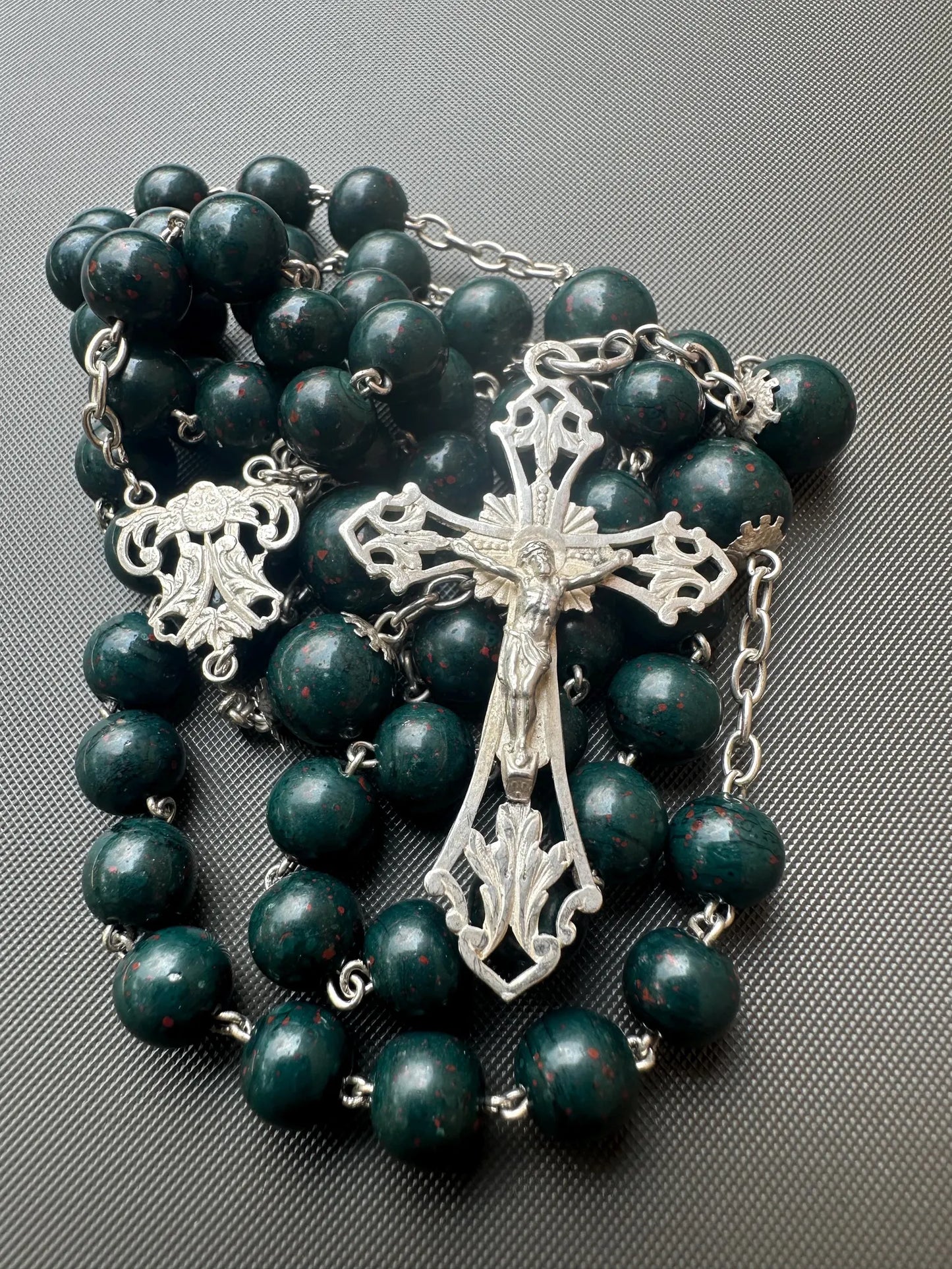 Antique bloodstone rosary with sterling silver crucifix on white background