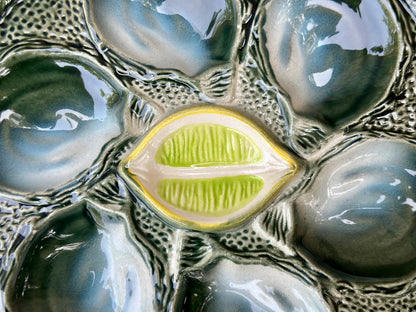 Vintage French Majolica oyster plate by Saint Clément, circa 1930, with six green-blue shell wells and a central lemon design, glazed ceramic faience, Art Deco coastal decor.