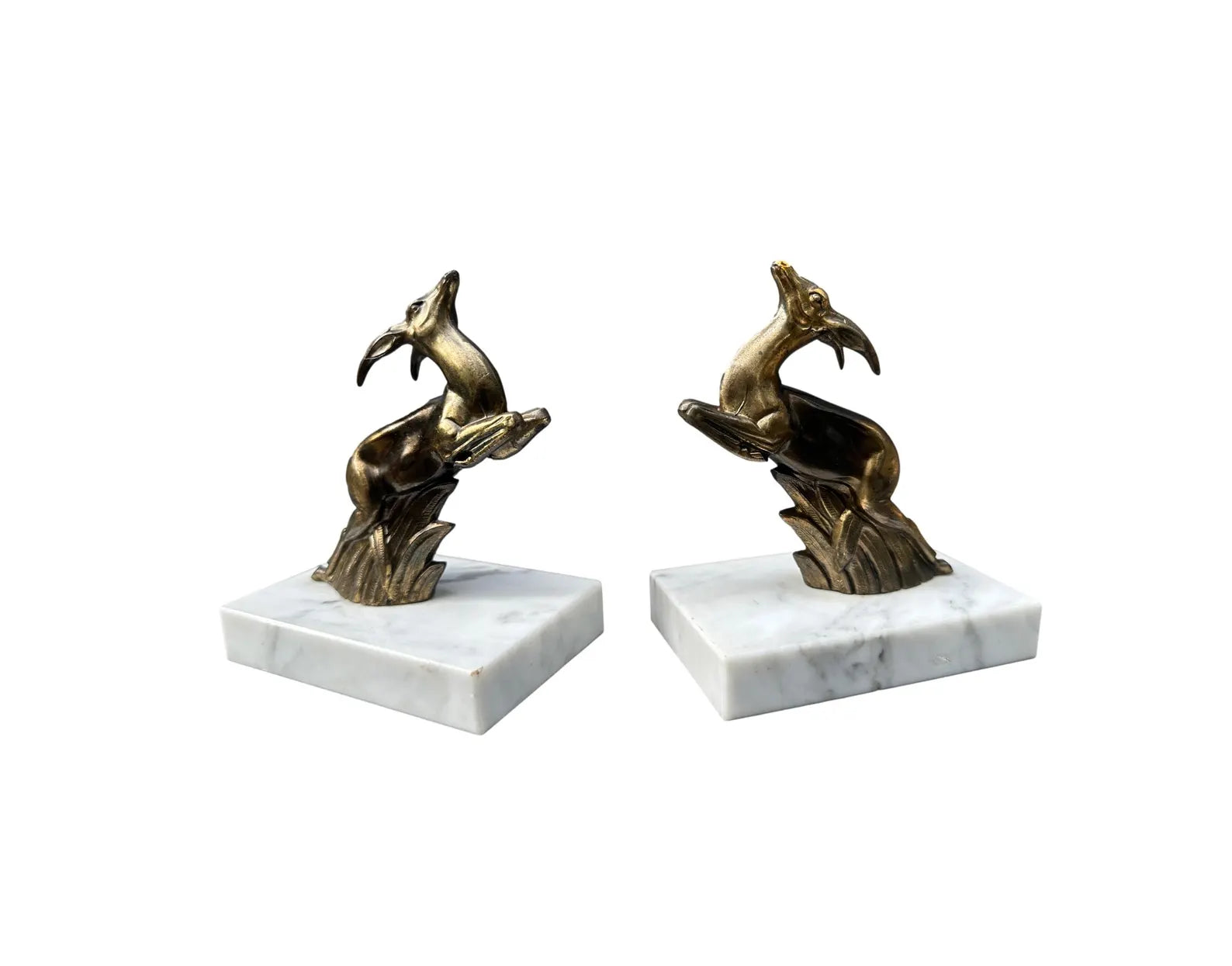 930s French Art Deco bookends featuring elegant antelope figures on a white marble base. A beautiful vintage design that combines functionality with timeless style.