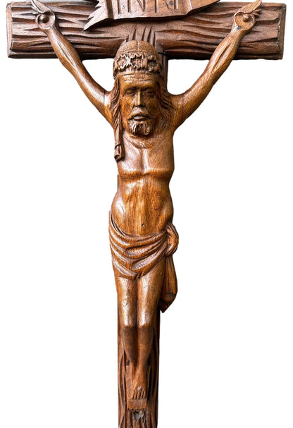 Close-up of a large hand-carved wood wall cross featuring a detailed wooden Jesus corpus statue. A stunning piece of folk art perfect for altars or rustic home decor.