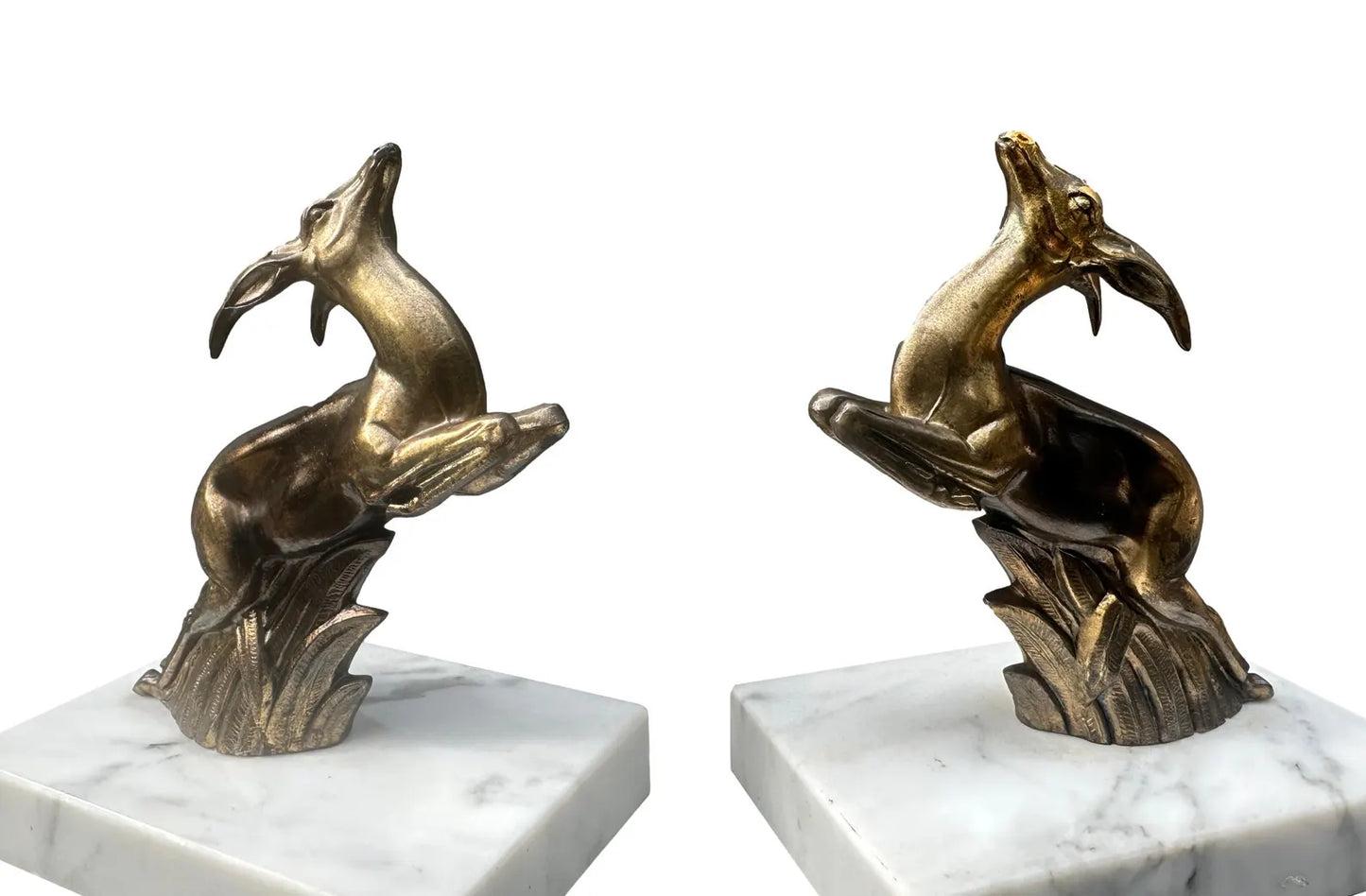 1930s French Art Deco bookends featuring elegant antelope figures on a white marble base. A beautiful vintage design that combines functionality with timeless style.