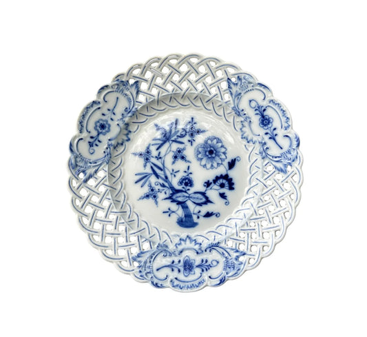 Close-up of an antique Meissen porcelain reticulated plate in the classic Blue Onion pattern. Beautifully detailed blue and white craftsmanship, perfect for collectors and decor