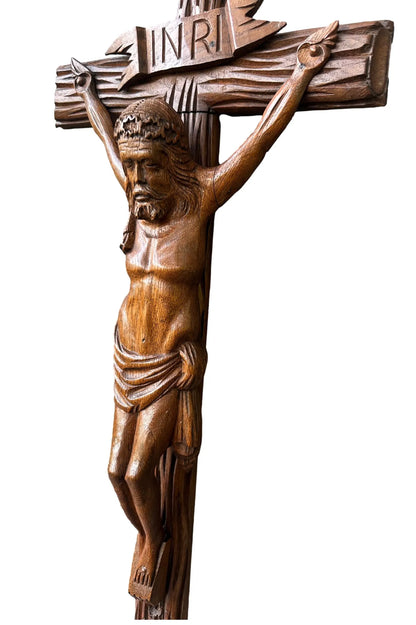 Close-up of a large hand-carved wood wall cross featuring a detailed wooden Jesus corpus statue. A stunning piece of folk art perfect for altars or rustic home decor.