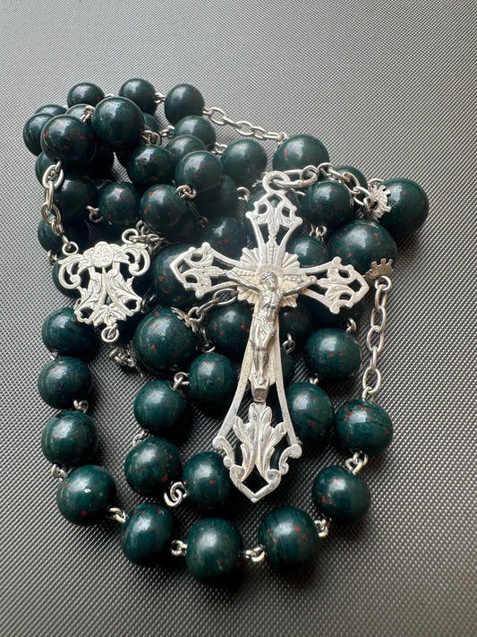 Antique bloodstone rosary with sterling silver crucifix on white background