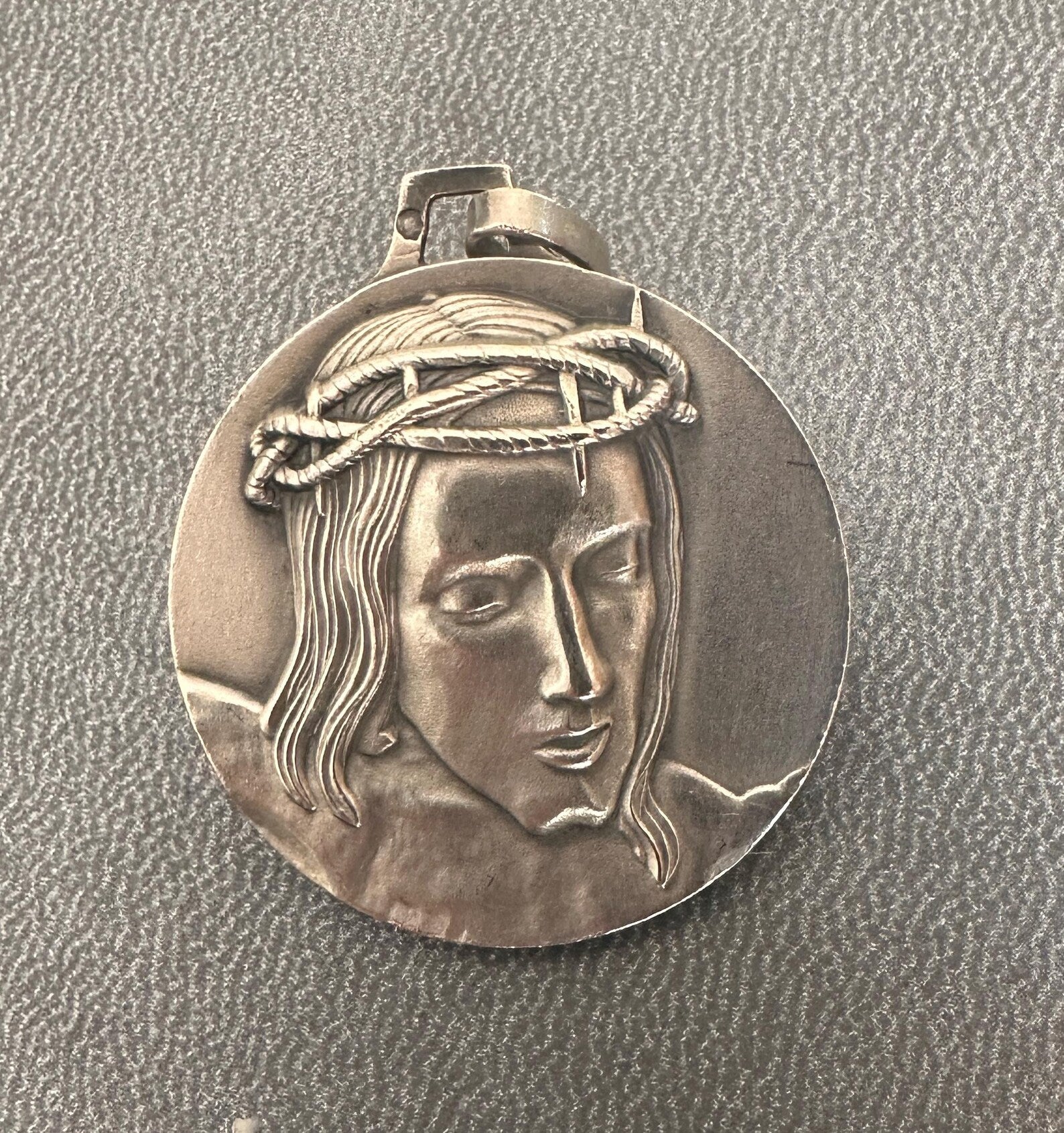 Solid silver medal with high-relief Christ crowned with thorns, Minerva hallmark, Cunfraterna di Santa Croce Bastia inscription.