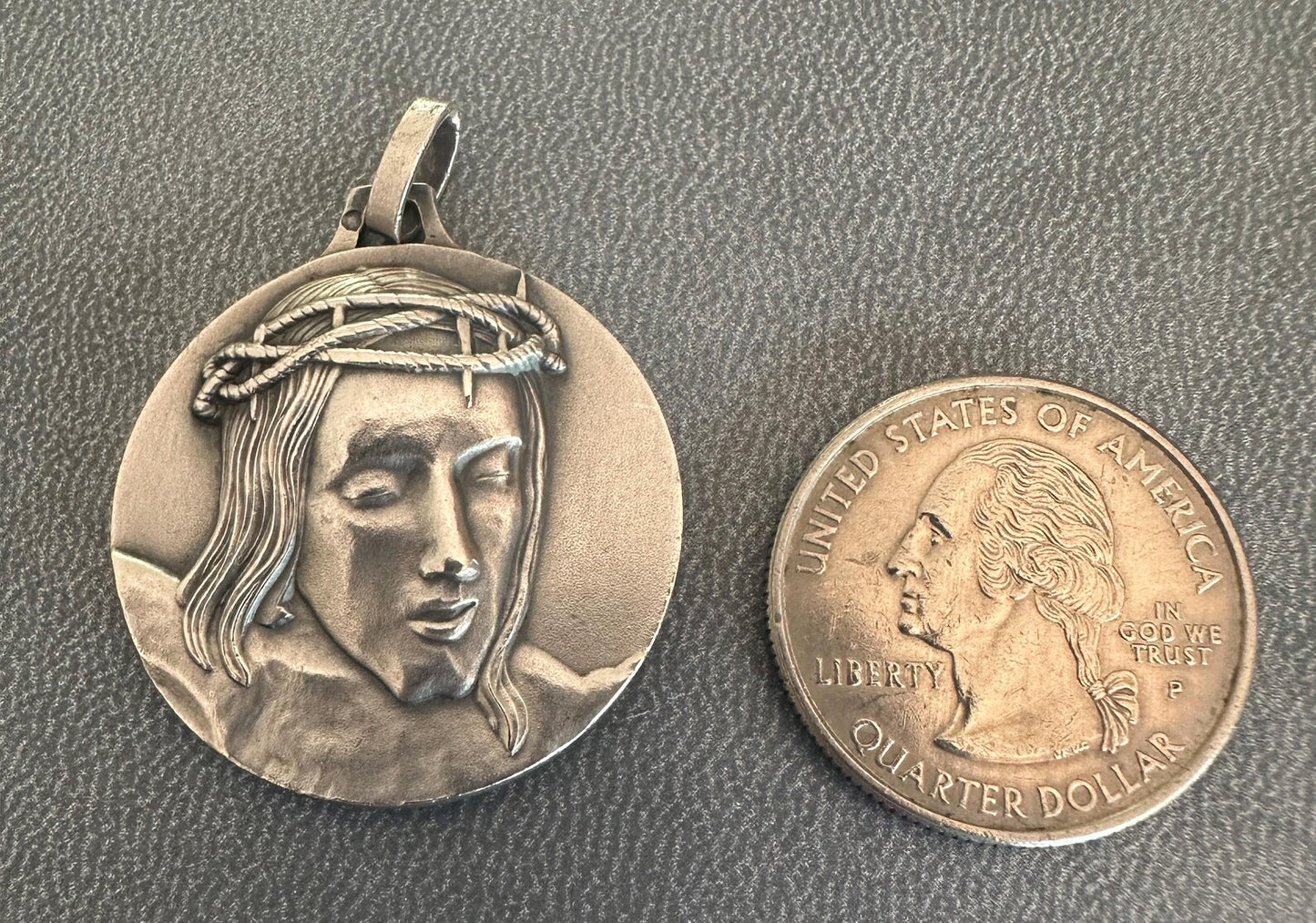 Solid silver medal with high-relief Christ crowned with thorns, Minerva hallmark, Cunfraterna di Santa Croce Bastia inscription.